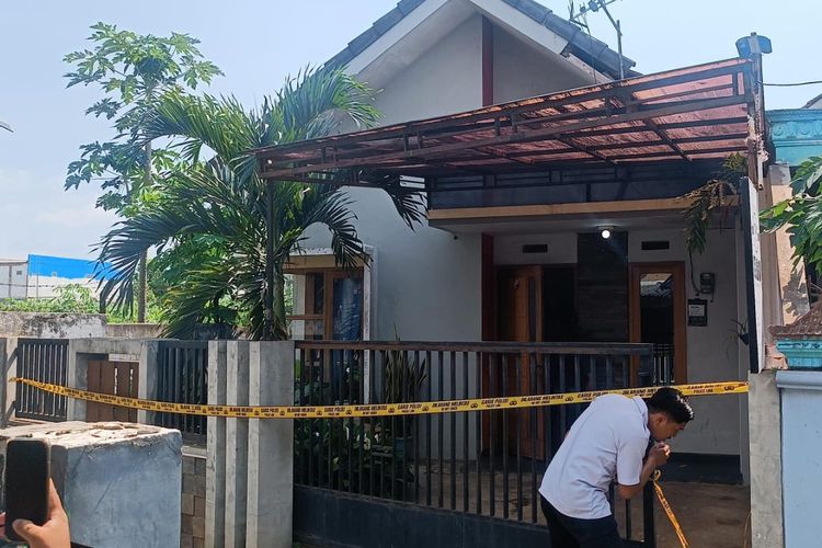 Polisi saat melakukan olah TKP di rumah korban yang ditemukan tewas satu keluarga di Desa Saptorenggo, Kecamatan Pakis, Kabupaten Malang, Selasa (12/12/2023).