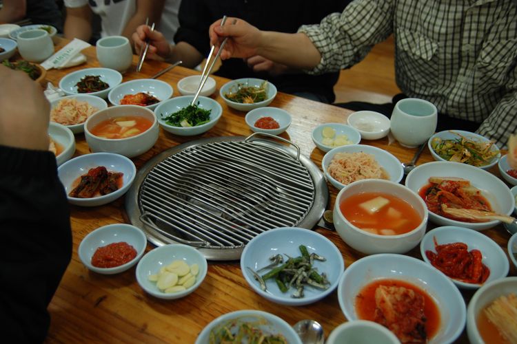 Illustration of Korean BBQ with various banchan.