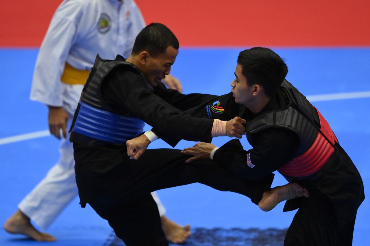 Pesilat Indonesia Khoirudin Mustakim (kiri) menyerang pesilat Malaysia Muhammad Khairi Adib Bin Azhar (kanan) pada final kelas B 50-55 Kg Pencak Silat SEA Games 2021 Vietnam di Bac Tu Liem Sport Center, Hanoi, Vietnam, Senin (16/5/2022). Pesilat Indonesia Khoirudin Mustakim meraih medali perak setelah kalah dari pesilat Malaysia Muhammad Khairi Adib Bin Azhar. ANTARA FOTO/Zabur Karuru/rwa.