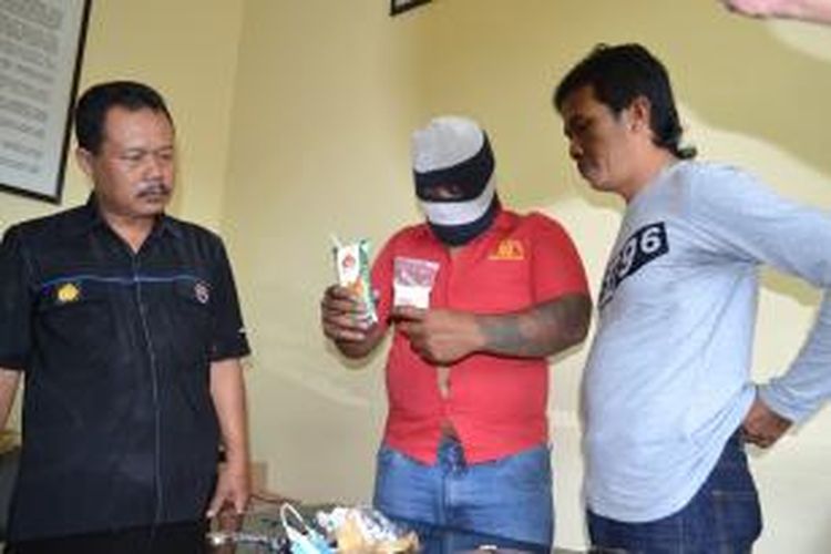   Sugeng Prihadi alias Gembrot (44) (tengah) menunjukkan barang satu paket sabu saat gelar perkara di Mapolres Magelang, Jawa Tengah, Jumat (11/9/2015).