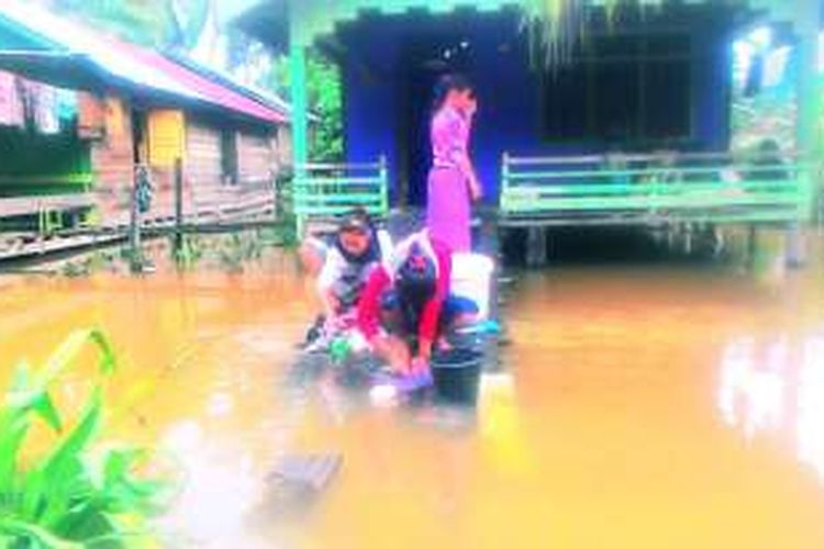 Warga bertahan di tengah banjir yang melanda di Desa Cingkam, Kecamatan Gunung Meriah, Aceh Singkil, Senin (28/11/2016)