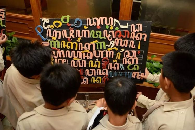 Peajar menggunakan alat edukasi aksara Jawa yang dipamerkan saat kegiatan Kongres Bahasa Java VI di Hotel Inna Garuda, Yogyakarta, Rabu (9/11).