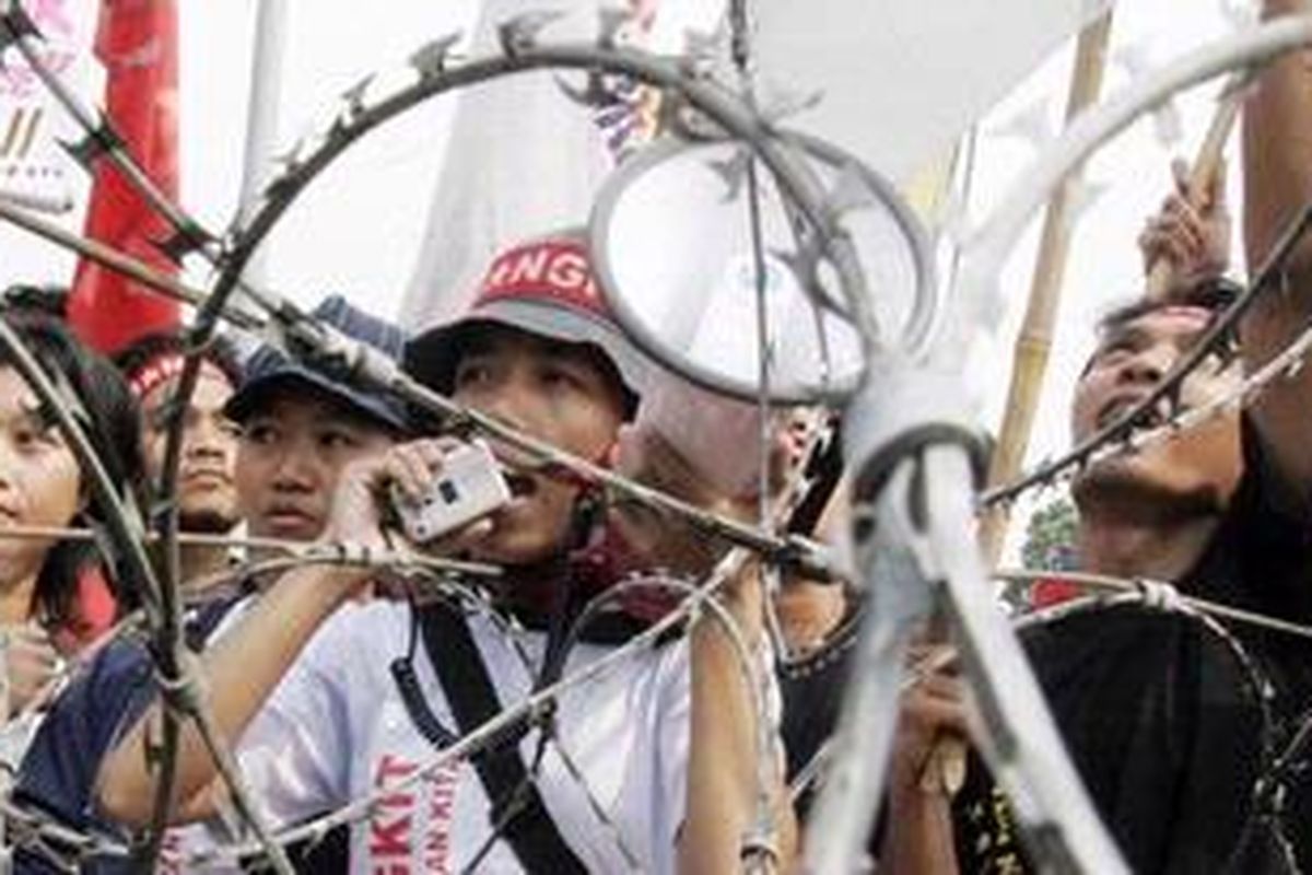 KEPUNG ISTANA - Sejumlah buruh demonstran menggelar aksi memperingati Hari Buruh Sedunia, didepan Istana Merdeka, Jakarta. Ribuan pengunjuk rasa yang tergabung dalam berbagai organisasi buruh tersebut turun ke jalan antara lain menuntut peningkatan kesejahteraan pekerja dan memenuhi hak-hak buruh. 