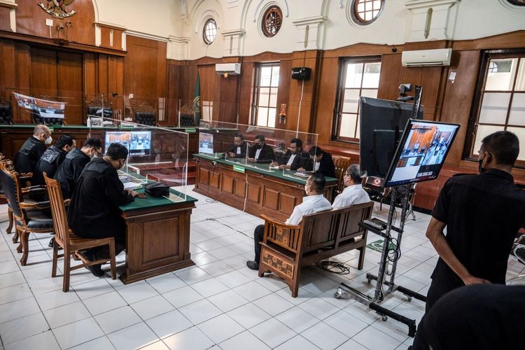Suko Sutrisno (front-left), a security official, and Abdul Haris (front-right), a match organizer, attend their trial at a courthouse in Surabaya on March 9, 2023. An Indonesian court on March 9 jailed two football match officials for negligence over one of the worst stadium disasters in the sport's history. The crush in October 2022 at a venue in the East Java city of Malang killed 135 people after police fired tear gas into packed stands when supporters invaded the pitch.