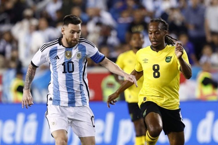 Hasil Argentina Vs Jamaika: Lionel Messi (kiri) mendapat pengawalan dari Daniel Johnson (kanan) pada laga uji coba FIFA Matchday yang mempertemukan Argentina vs Jamaika di Red Bull Arena, New Jersey, Amerika Serikat, Rabu (28/9/2022) pagi WIB.