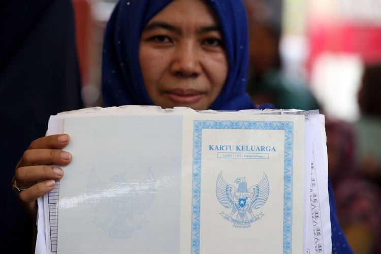 Warga menunjukkan persyaratan pencetakan e-KTP di stan pelayanan dan pencetakan e-KTP di Taman Mini Indonesia Indah (TMII), Jakarta, Jumat (20/10/2017).  Kegiatan yang digelar antara Dinas Kependudukan dan Catatan Sipil DKI bekerja sama dengan Direktorat Jenderal Kependudukan dan Catatan Sipil Kementerian Dalam Negeri ramai diserbu warga yang yang belum memiliki e-KTP.