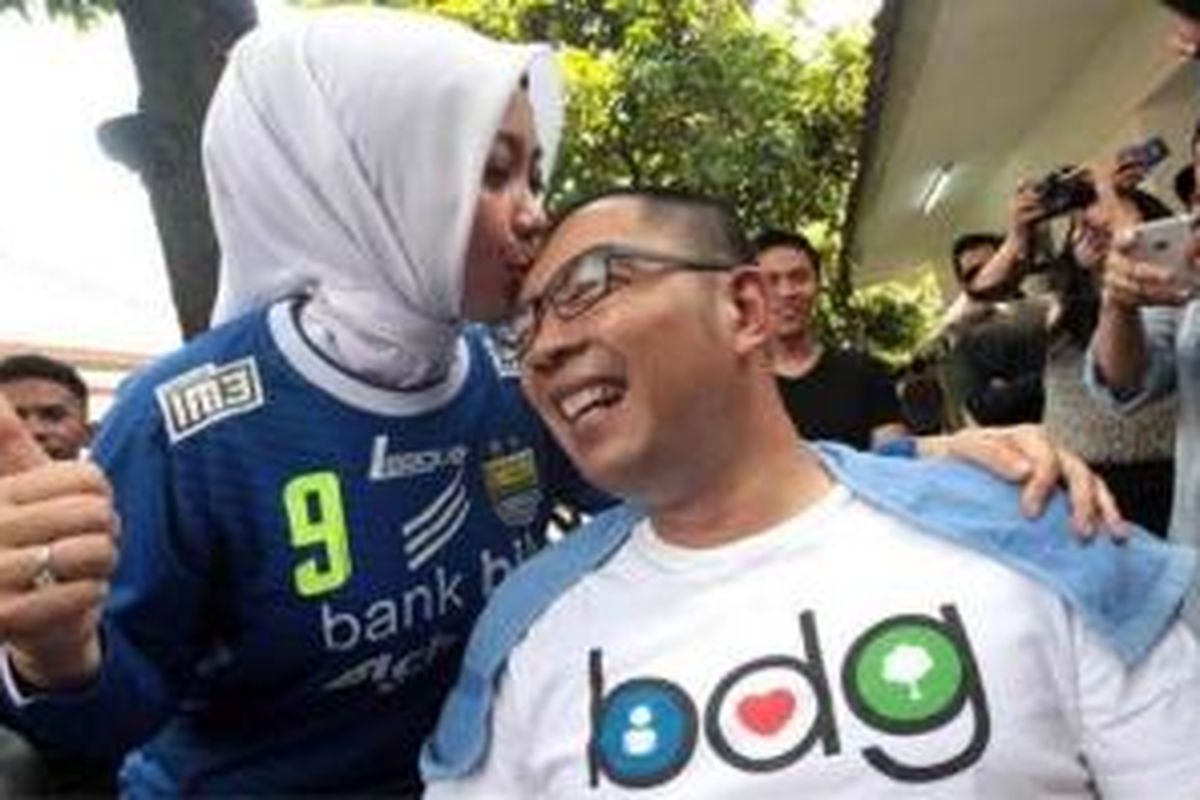 Wali Kota Bandung, Ridwan Kamil mendapat ciuman di kepalanya yang baru saja dicukur pendek dari sang istri tercinta, Atalia Prataya di Pendopo, Minggu (9/11/2014).