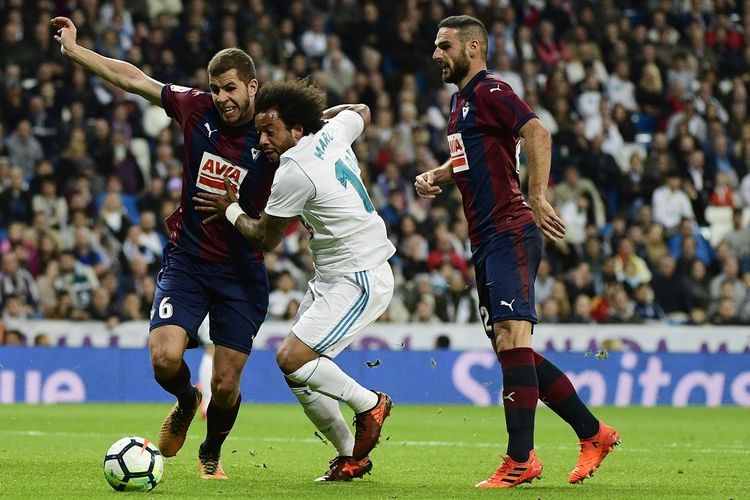 Bek Real Madrid Brasil Marcelo menantang bek Eibar Spanyol David Lomban (kanan) dan gelandang Spanyol Eibar Christian Rivera selama pertandingan sepak bola liga Spanyol Real Madrid CF vs SD Eibar di stadion Santiago Bernabeu di Madrid pada 22 Oktober 2017.