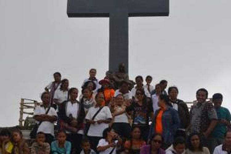 Berpose di depan Salib Yesus di Puncak Wolowio, di Kecamatan Bajawa, Kabupaten Ngada, Nusa Tenggara Timur.