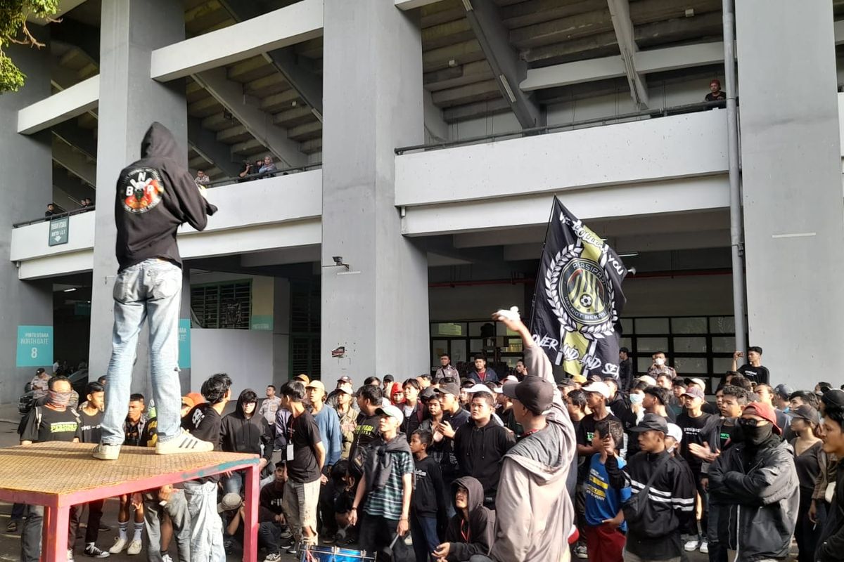 Suporter sepak bola dari klub Persipasi Kota Bekasi saat menggelar aksi solidaritas terhadap para korban yang meninggal dunia dalam Tragedi Kanjuruhan. Sebagai aksi solidaritas, suporter Persipasi mengosongkan bangku penonton di tribun utara dalam laga Persipasi Kota Bekasi melawan PSB Bogor, Minggu (2/10/2022) sore. 