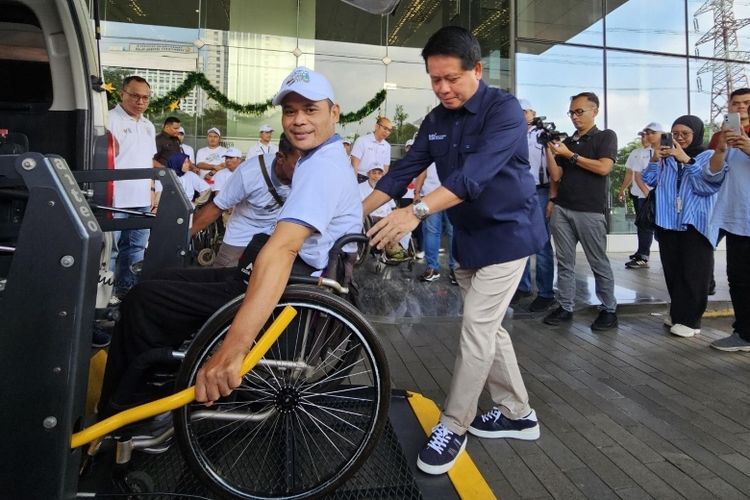 Direktur Utama BSI Hery Gunardi (kanan) antusias membantu mendorong pemudik naik ke mobil khusus disabilitas saat pelepasan peserta Mudik Asyik Bersama BUMN dan BSI 2024.