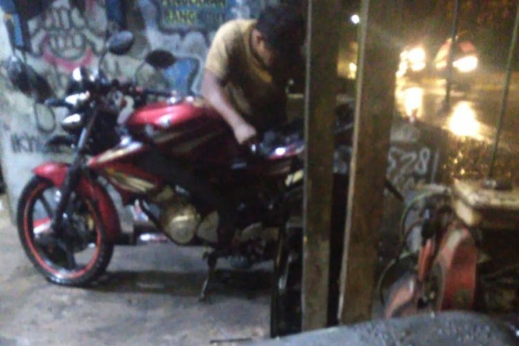 Seorang teknisi bengkel tengah meperbaiki motor Hamjah, pemudik dari Karawang.