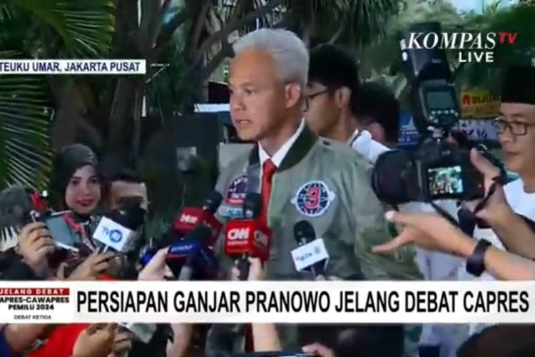 Tangkapan layar capres nomor urut 3 Ganjar Pranowo tiba di High End, Jakarta Pusat, Minggu (7/1/2024) sebelum menghadapi debat capres kedua, di Istora Senayan. Ganjar menggunakan jaket bomber hijau army senada dengan cawapres pendampingnya, Mahfud MD.