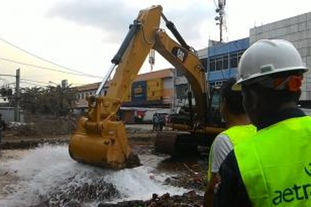 Sebuah pipa milik PT Aetra di jalan Inspeksi Tarum Barat, Duren Sawit, Jakarta Timur, bocor terkena alat berat, Selasa (14/4/2015).