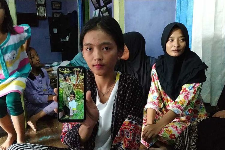 Puja (18) menujukkan foto ibu dan adiknya yang mnjeadi korban kecelakaan bus Sriwijaya yang jatuh ke jurang saat melintas di Liku Lematang, Desa Prahu Dipo, Kecamatan Dempo Tengah , kota Pagaralam, Sumatera Selatan.
