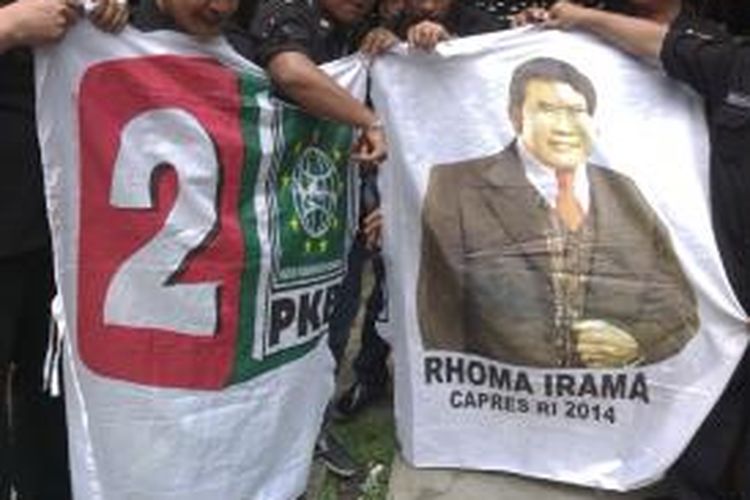 Aksi gunting bendera yang terdapat lambang Partai Kebangkitan Bangsa dan foto Rhoma Irama, di rumah makan kawasan Jakarta Barat, Kamis (15/5/2014)