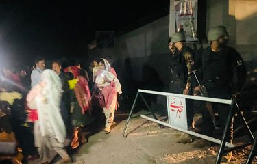Petugas keamanan menutup jalan saat penduduk setempat mengungsi dari rumah mereka di dekat lokasi serangan di Muzaffarabad, ibu kota Kashmir yang dikelola Pakistan, pada 7 Mei 2025. India menembakkan rudal ke wilayah Pakistan pada 7 Mei dini hari dalam peningkatan ketegangan yang besar antara kedua rival bersenjata nuklir tersebut, dengan Islamabad bersumpah akan melakukan pembalasan.