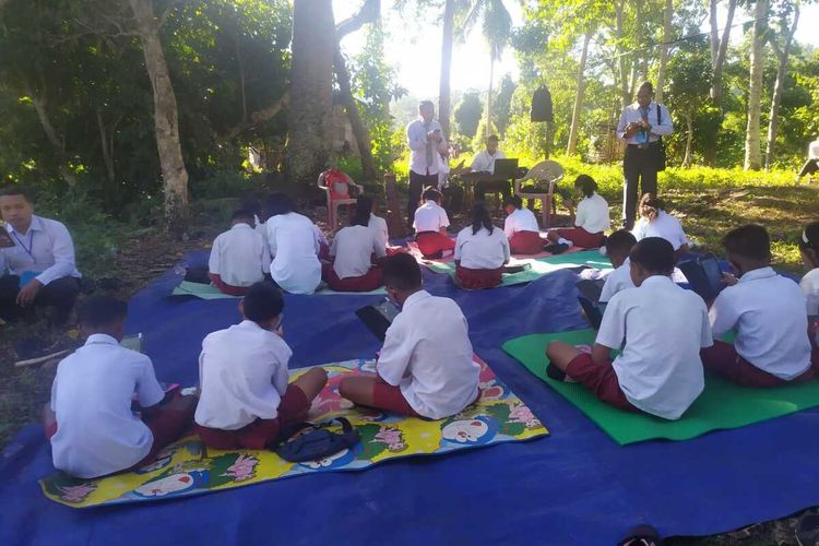 Siswa Kelas VI dari SDI Nunur dan SDK Waekekik melaksanakan USBD di lereng bukit Leje, Kampung Mok, Desa Mbengan, Kecamatan Kota Komba, Kabupaten Manggarai Timur, NTT, Selasa, (27/4/2021). USBD melaksanakan ujian di lereng bukit karena susah sinyal di ruangan kelas di dua sekolah tersebut. (KOMPAS.com/DOK-SDK WAEKEKIK)