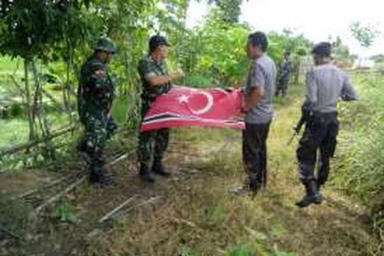 Aparat gabungan menurunkan bendera GAM di Desa Buket Linteung Kecamatan Langkahan, Aceh Utara, Minggu (4/12/2016)