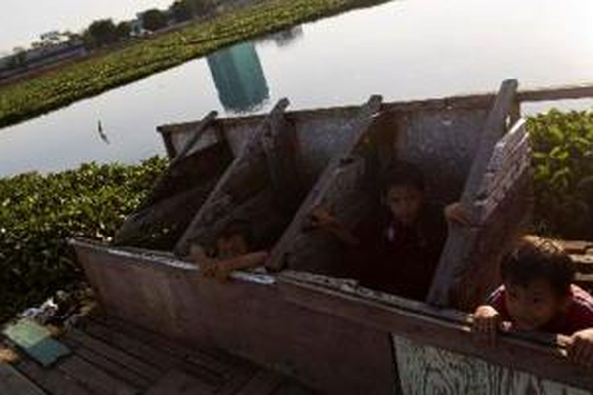 Anak-anak bermain di toilet umum yang terdapat di kawasan Waduk Ria Rio, Pedongkelan, Jakarta Timur. Foto diambil bulan Agustus 2008. Di Jakarta, satu juta orang masih buang air besar sembarangan di sungai, laut, atau di permukaan tanah. 