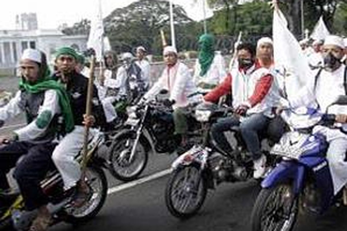 Puluhan massa ormas berkonvoi usai terlibat bentrok dengan massa Aliansi Kebangsaan untuk kebebasan Beragama dan Berkeyakinan (AKK-BB) di Halaman Parkir Monumen Nasional , Jakarta. Minggu (1/6).