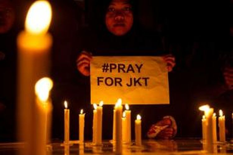 Seorang remaja putri di Surabaya membawa kertas bertuliskan Pray for Jakarta setelah kejadian kemarin.