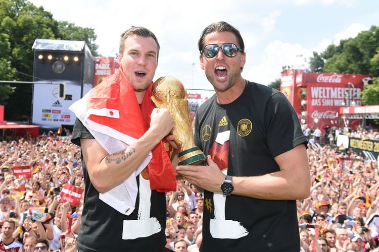 Kevin Grosskreutz (kiri) dan Roman Weidenfeller merayakan kesuksesan tim nasional (timnas) Jerman menjuarai Piala Dunia 2014 di Berlin, 15 Juli 2014.