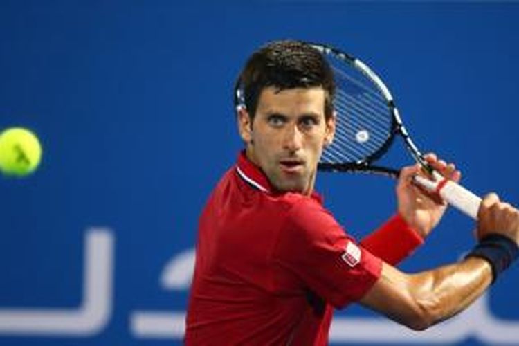 Petenis Serbia, Novak Djokovic, mengembalikan bola dari petenis Swiss, Stanislas Wawrinka, pada semifinal turnamen Mubadala World Tennis Championship di Abu Dhabi, Jumat (2/1/2015). Djokovic menang 6-1 6-2.