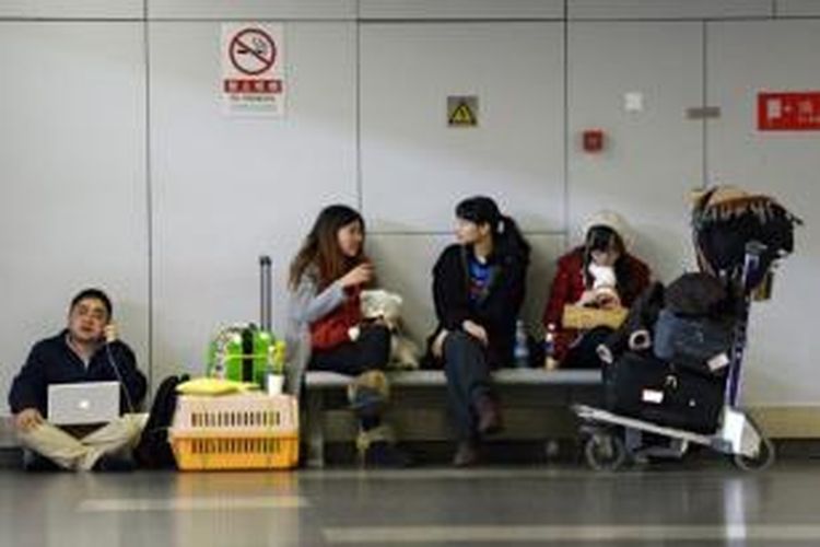 Sejumlah penumpang tengah menunggu penerbangan mereka di bandara Capital International Beijing, China. 