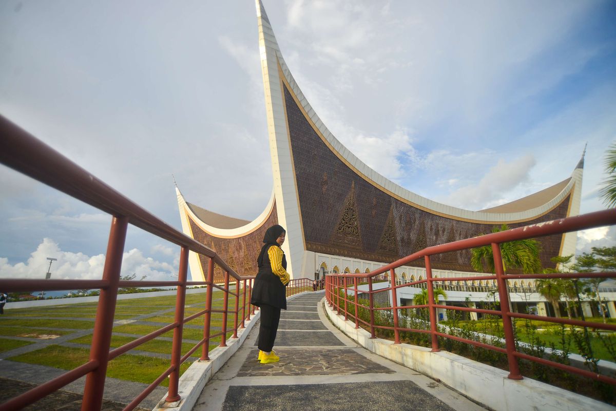 Pengunjung berjalan di pedestrian halaman Masjid Raya Sumatera Barat (Sumbar), di Padang, Rabu (13/4/2022). Masjid yang meraih penghargaan sebagai masjid dengan desain arsitektur terbaik di dunia dalam kompetisi Arsitektur Masjid Abdullatif Al Fozan tahun 2021 itu, ramai dikunjungi selama bulan ramadhan untuk beribadah sekaligus berwisata karena merupakan ikon wisata religi di kota itu.