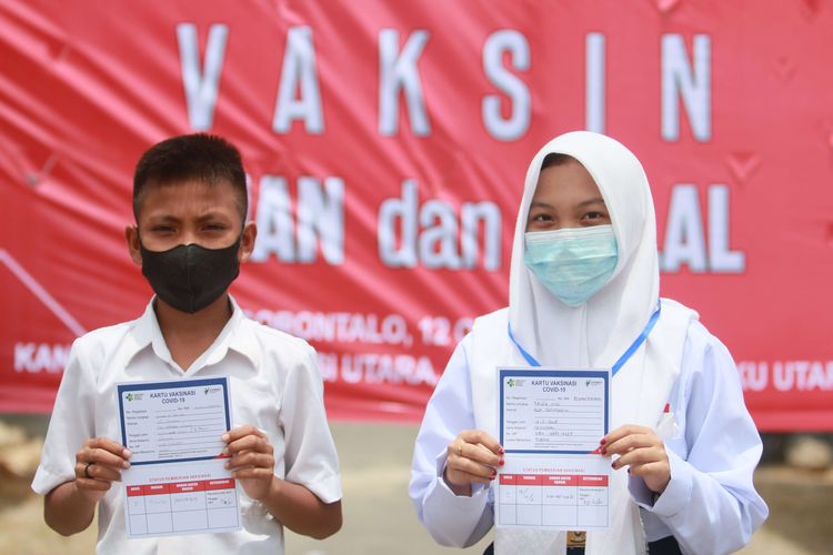 Pelajar menunjukkan kartu vaksinasi Covid-19 seusai mendapat suntikan vaksin di Markas Korem 133/Nani Wartabone, Kabupaten Gorontalo, Gorontalo, Selasa (12/10/2021). OJK menggandeng Korem 133/Nani Wartabone, KPw Bank Indonesia Gorontalo dan Pemerintah Provinsi Gorontalo pada kegiatan serbuan vaksinasi dengan menyasar 1.000 peserta dari kalangan pelajar hingga masyarakat umum dalam rangka percepatan capaian vaksinasi Covid-19.
