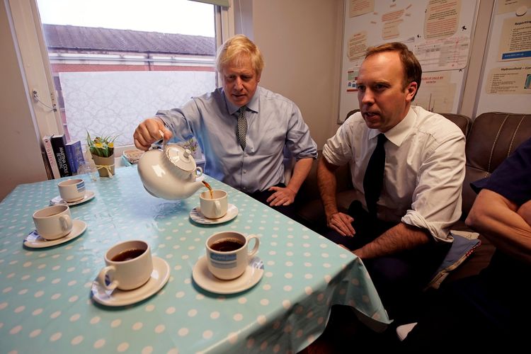 Perdana Menteri Inggris Boris Johnson dan Menteri Kesehatan Matt Hancock menikmati teh ketika mengunjungi Rumah Sakit Umum Distrik Bassetlaw di Worksop, pada 22 November 2019. Keduanya mengumumkan terinfeksi virus corona dalam rentang waktu beberapa jam.