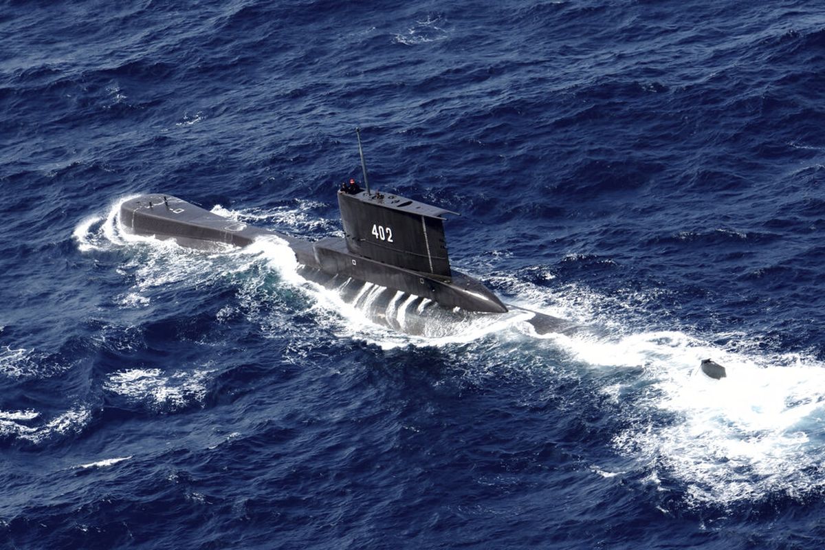 Indonesian Navy submarine KRI Nanggala sails in the waters off Tuban, East Java, Indonesia, as seen in this aerial photo taken from Indonesian Navy helicopter of 400 Air Squadron, in this Monday, Oct. 6, 2014 photo. Indonesia's navy is searching for the submarine that went missing north of the resort island of Bali with a number of people on board, the military said Wednesday. (AP Photo/Eric Ireng)