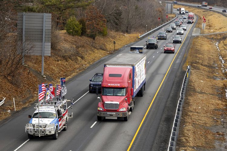Scranton, Pa. area businessman Bob Bolus drives his semi truck leading a Freedom Convoy on Interstate 81 southbound in Pittston Twp., Pa on Wednesday, Feb. 23, 2022. The Pentagon has approved the deployment of 700 unarmed National Guard troops to the nation?s capital as it prepares for trucker convoys that are planning protests against pandemic restrictions beginning next week.  (Christopher Dolan/The Times-Tribune via AP)