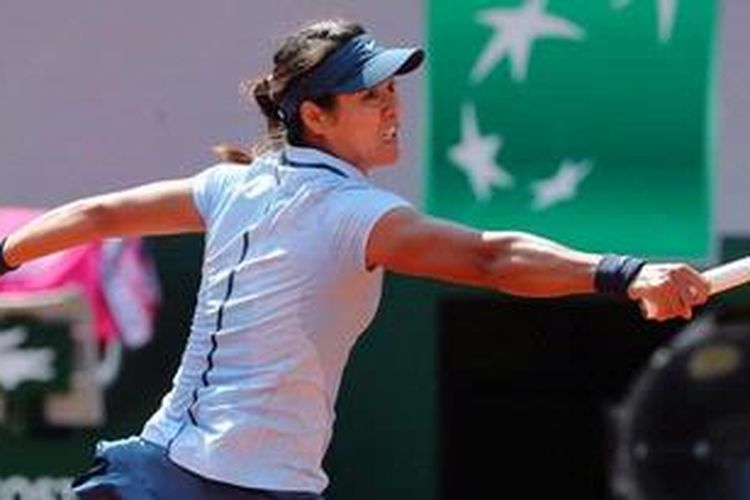Petenis China, Li Na, berusaha mengembalikan bola dari petenis Spanyol, Anabel Medina Garrigues, di babak pertama French Open, Senin (27/5/2013).