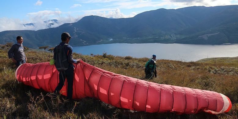 Tim paralayang Mapala UI dalam Ekspedisi Bumi Cenderawasih tengah melakukan persiapan lepas landas melintasi Danau Anggi Gida dan Anggi Giji dari Bukit Kombrey, Distrik Anggi, Kabupaten Pegunungan Arfak, Papua Barat, Jumat (17/8/2018) sore. Danau Anggi Gida dan Anggi Giji merupakan obyek wisata yang berpotensi untuk dikembangkan wisata minat khusus seperti paralayang.