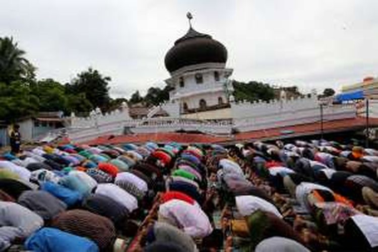 Warga melaksanakan sholat Jumat di halaman Masjid Jamik Quba, Pidie Jaya, Aceh, Jumat (9/12/2016). Warga melaksanakan Salat Jumat di halaman masjid dikarenakan robohnya masjid akibat gempa berkekuatan 6,5 SR di Pidie Jaya.