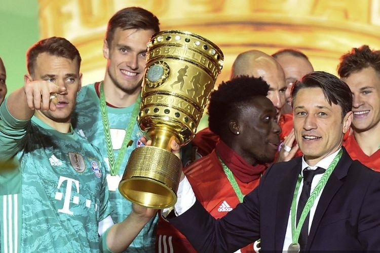 Kapten Manuel Neuer dan pelatih Niko Kovac mengangkat piala DFB Pokal seusai Bayern Muenchen menang telak atas RB Leipzig di Olympiastadion pada laga final, 25 Mei 2019. 