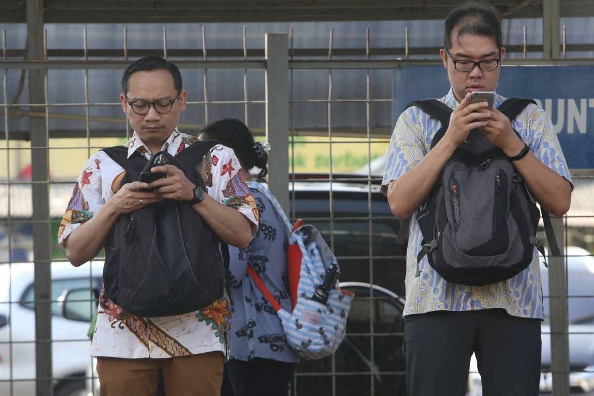Sejumlah warga menunggu kereta di Stasiun Rawabuntu, Tangerang, Banten, Senin (02/10/2017). Untuk memperingati Hari Batik Nasional yang jatuh setiap tanggal 2 Oktober para pekerja kantoran baik negeri maupun swasta menggunakan pakaian batik.