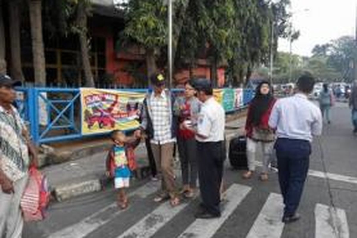 Seorang petugas terminal tampak memintai uang kepada para calon penumpang di Terminal Kampung Rambutan, Rabu (15/7/2015). Petugas tersebut menyebut pungutan yang mereka lakukan adalah biaya peron terminal. Akan tetapi penumpang yang dikenakan pungutan tidak mendapatkan bukti pembayaran.