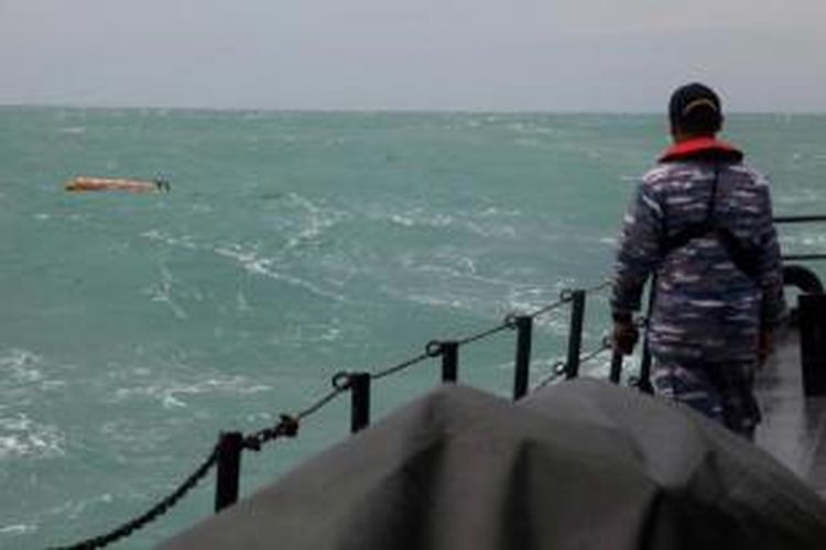 Anggota TNI AL melihat benda yang diduga serpihan pesawat AirAsia QZ8501 di Selat Karimata, Sabtu (3/1/2015).