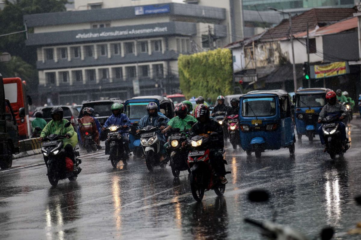 Pengguna kendaraan bermotor menembus hujan di Jalan Menteng Raya, Jakarta, Jumat (22/2/2019). Badan Meteorologi, Klimatologi, dan Geofisika ( BMKG) memprediksi hujan akan mengguyur wilayah Jabodetabek pada Jumat (22/2/2019) siang.