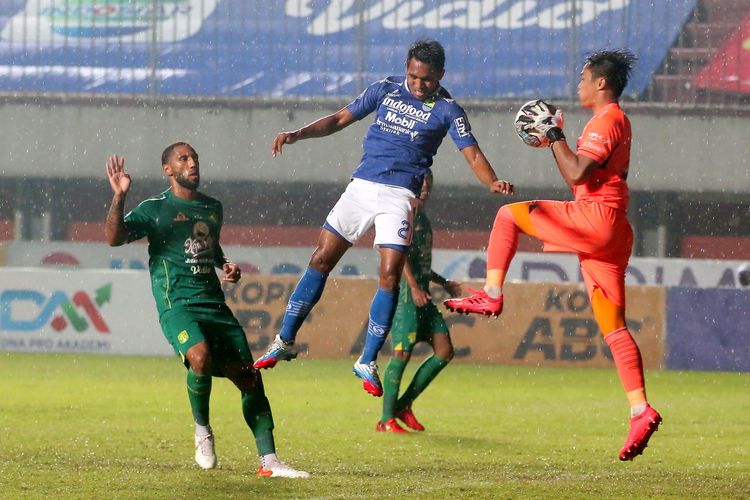 Penjaga gawang Persebaya Surabaya Ernando Ari Sutaryadi menangkap sundulan pemain Persib Bandung Frets Butuan saat pertandingan pekan 16 Liga 1 2021-2022 yang berakhir dengan skor 0-3 di Stadion Maguwoharjo Sleman, Rabu (8/12/2021) malam.