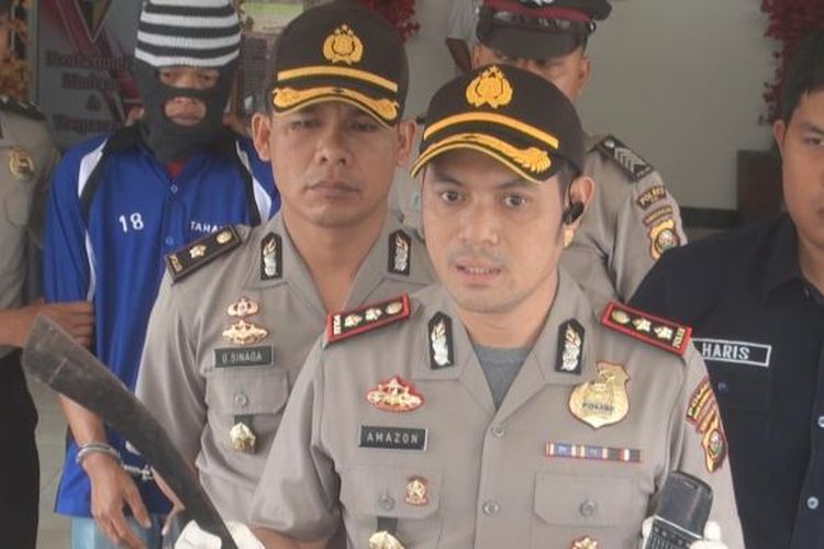 Kapolres OKI AKBP Amazona menunjukkan barang bukti parang yang digunakan tersangka membunuh korban dan telepon selular yang digunakan korban menelpon istrinya.