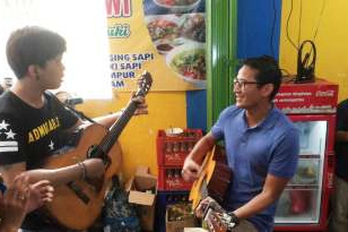 Calon wakil gubernur DKI Jakarta nomor tiga, Sandiaga Uno saat berduet bermain gitar dan bernyanyi dengan salah seorang pengamen di kawasan Rawasari Selatan, Cempaka Putih, Jakarta Pusat, Rabu (30/11/2016). 