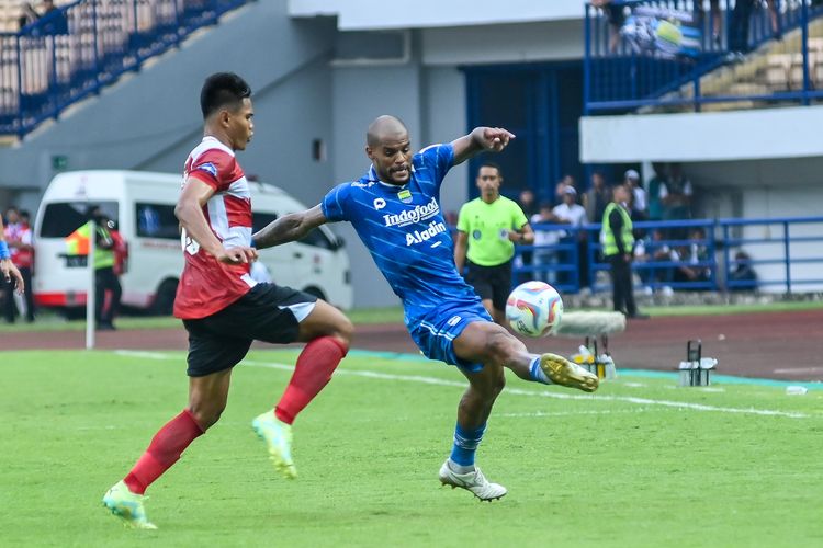 Penyerang Persib David da Silva mencoba menghindari adangan bek Madura United Fachruddin Aryanto dalam pertandingan pertama Liga 1 2023-2024 yang berlangsung di Stadion Gelora Bandung Lautan Api (GBLA), Minggu (2/7/2023).