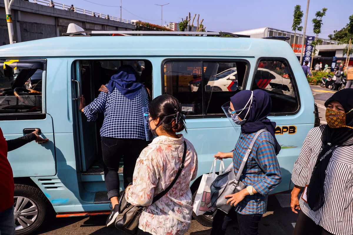 Pekerja menggunakan masker saat memasuki angkutan umum di Kawasan Tanah Abang, Jakarta Pusat, Senin (21/9/2020). PSBB kembali diterapkan tanggal 14 September 2020, berbagai aktivitas kembali dibatasi yakni aktivitas perkantoran, usaha, transportasi, hingga fasilitas umum.