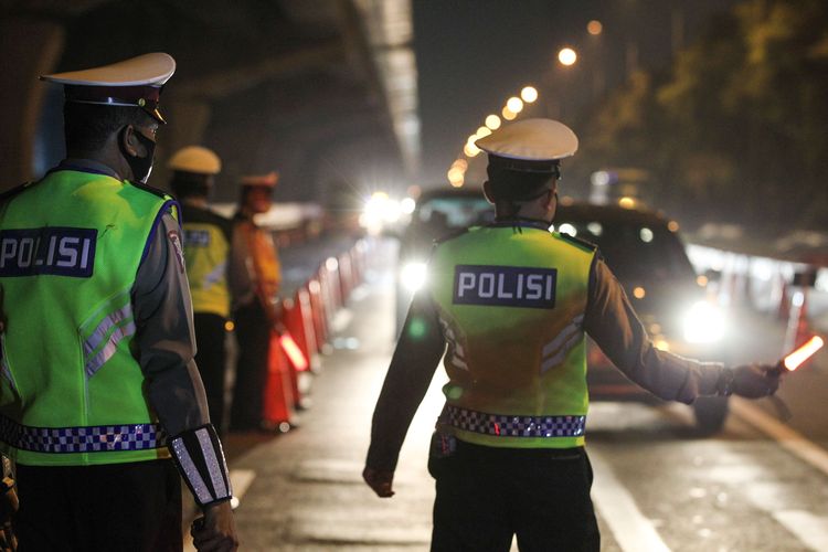 bPetugas melakukan pemeriksaan pada H-1 Lebaran di check point penyekatan pertama di ruas tol Jakarta - Cikampek Km 31, Kabupaten Bekasi, Jawa Barat, Sabtu (23/5/2020). Larangan diberlakukan pemerintah untuk mencegah penyebaran Covid-19 melalui Operasi Ketupat 2020. Kendaraan pribadi baik motor atau mobil dan kendaraan umum berpenumpang dilarang keluar dari wilayah Jabodetabek.