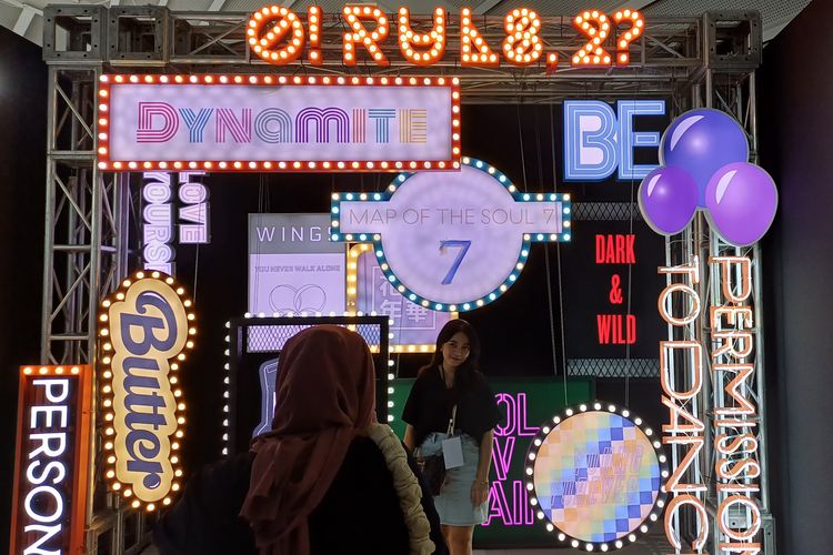 Pengunjung BTS Exhibition: Proof in Jakarta berfoto di depan titik yang telah ditentukan, yang menampilkan semua judul lagu BTS selama 10 tahun berkarier.