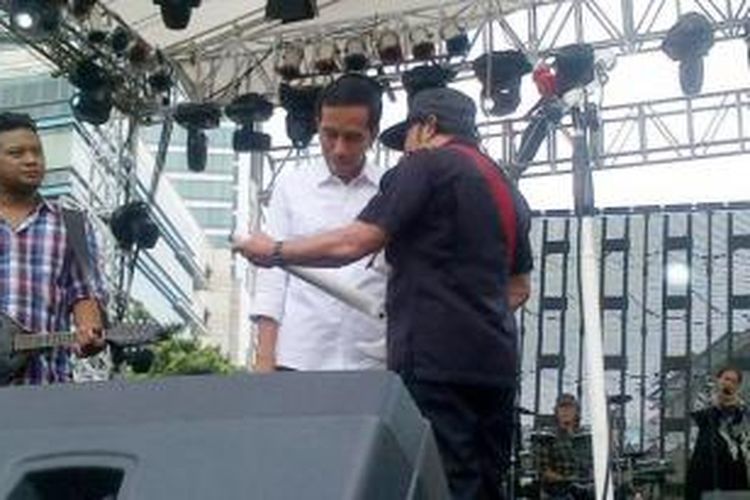 Gubernur DKI Jakarta, Joko Widodo (berkemeja putih) tengah mendengarkan arahan dari musisi Rhoma Irama di atas panggung utama Jakarta Night Festival, Selasa (31/12/2013). Keduanya akan berduet guna memeriahkan acara malam pergantian tahun.